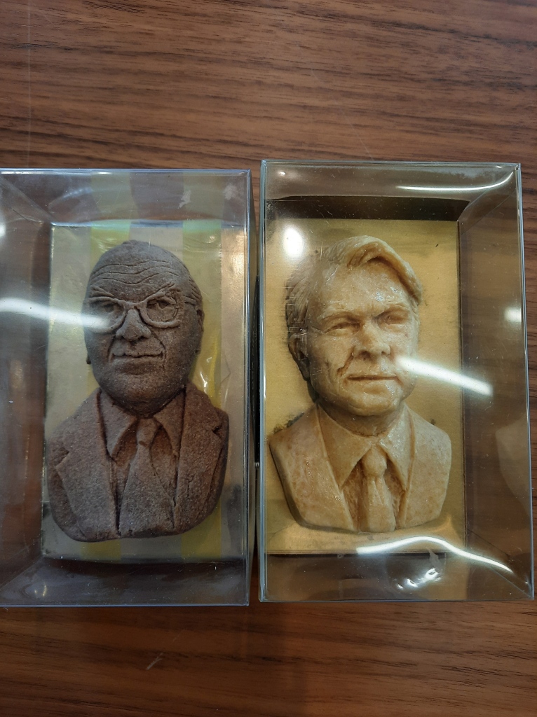 marzipan busts of Roy Jenkins and David Owen, former leaders of the SDP. The Roy Jenkins bust has discoloured and is dark brown, but the Owen bust is still the usual colour of marzipan. They are in transparent plastic boxes 